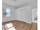 Light-filled bedroom with wood-look floors and ceiling fan at 5012 76Th E St, Bradenton, FL 34203