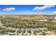 Aerial view of a residential area featuring houses, trees, and a pond at 5122 Creekside Trl, Sarasota, FL 34243