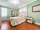 Serene bedroom with wood floors, a ceiling fan, and a green color scheme at 5122 Creekside Trl, Sarasota, FL 34243