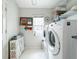 Laundry room with washer, dryer, and storage at 5122 Creekside Trl, Sarasota, FL 34243