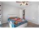 Cozy bedroom with a bed featuring a cars themed comforter and ceiling fan at 7741 Forest Trl # 6, Port Richey, FL 34668