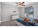 Bedroom with car-themed bedding and ceiling fan at 7741 Forest Trl # 6, Port Richey, FL 34668