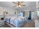 Main bedroom with a king-size bed, ceiling fan, and coastal-themed bedding at 7741 Forest Trl # 6, Port Richey, FL 34668