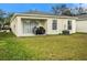 Backyard with patio, grill, and grassy area at 7833 Carriage Pointe Dr, Gibsonton, FL 33534