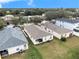 This backyard features a grassy area, an AC unit, and access to the other homes in the community at 7833 Carriage Pointe Dr, Gibsonton, FL 33534