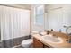This bathroom offers a shower-tub combo, vanity, and neutral finishes at 7833 Carriage Pointe Dr, Gibsonton, FL 33534