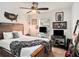 This cozy bedroom includes a ceiling fan and wood-styled headboard at 7833 Carriage Pointe Dr, Gibsonton, FL 33534