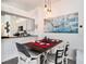 Charming dining area with a rustic table, pendant lighting, and an adjacent kitchen with modern appliances at 7833 Carriage Pointe Dr, Gibsonton, FL 33534