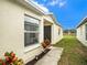 Charming home exterior with manicured lawn, walkway and decorative plants at 7833 Carriage Pointe Dr, Gibsonton, FL 33534