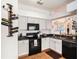 Well-equipped kitchen with a black oven, modern appliances, sleek countertops, and ample storage space at 7833 Carriage Pointe Dr, Gibsonton, FL 33534