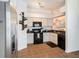 Charming kitchen with tile floor, white cabinets, and modern appliances offering a cozy cooking space at 7833 Carriage Pointe Dr, Gibsonton, FL 33534
