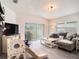Cozy living room features sliding glass door with a view, comfortable seating and plenty of natural light at 7833 Carriage Pointe Dr, Gibsonton, FL 33534