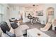 Open living space features hardwood floors, neutral colors, and an open flow into the dining area and kitchen at 7833 Carriage Pointe Dr, Gibsonton, FL 33534