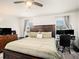 This main bedroom showcases a large bed, wood floors, and a functional desk area at 7833 Carriage Pointe Dr, Gibsonton, FL 33534