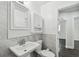 Clean bathroom with a pedestal sink and modern vanity at 8509 El Portal Dr, Tampa, FL 33604