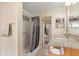 Bathroom with granite countertop, shower, and wood cabinets at 4042 Boulder Dr, New Port Richey, FL 34653