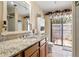 Bathroom with granite countertop, wood cabinets, and shower at 4042 Boulder Dr, New Port Richey, FL 34653