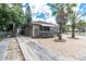 House exterior with palm trees, a paved driveway, and a well-maintained front yard at 4042 Boulder Dr, New Port Richey, FL 34653