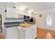 Modern kitchen with white cabinets, stainless steel appliances and a butcher block island at 4042 Boulder Dr, New Port Richey, FL 34653