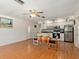 Bright kitchen with hardwood floors, white cabinets, and stainless steel appliances at 4042 Boulder Dr, New Port Richey, FL 34653