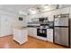 Modern kitchen with white cabinets, stainless steel appliances and butcher block island at 4042 Boulder Dr, New Port Richey, FL 34653