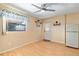 Bedroom with laminate wood flooring, ceiling fan, and access to the kitchen at 4042 Boulder Dr, New Port Richey, FL 34653