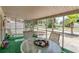 Relaxing screened porch with table and chairs at 4042 Boulder Dr, New Port Richey, FL 34653