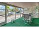 Screened porch with table, chairs, and green carpet at 4042 Boulder Dr, New Port Richey, FL 34653