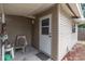 Cozy side porch with a chair and small table at 4042 Boulder Dr, New Port Richey, FL 34653
