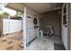 Covered side porch with seating and storage area at 4042 Boulder Dr, New Port Richey, FL 34653