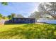 Large backyard with covered patio and green grass at 4234 Harrisburg Ne St, St Petersburg, FL 33703