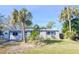 Light blue house with a white fence and palm trees at 4234 Harrisburg Ne St, St Petersburg, FL 33703