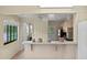 Bright kitchen features light wood cabinets, and a view to the backyard at 13620 Diamond Head Dr, Tampa, FL 33624