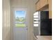 Kitchen with stainless steel refrigerator and backyard view at 13620 Diamond Head Dr, Tampa, FL 33624