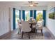 Sunlit dining area with seating for six and a view to the backyard at 141 Hobo Rd, Rotonda West, FL 33947