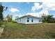 Single-story home with white exterior and grassy lawn at 141 Hobo Rd, Rotonda West, FL 33947