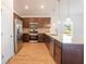 Modern kitchen with dark wood cabinets, stainless steel appliances, and a quartz countertop at 141 Hobo Rd, Rotonda West, FL 33947