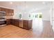 Modern kitchen with dark wood cabinets, stainless steel appliances, and a large island at 141 Hobo Rd, Rotonda West, FL 33947