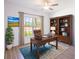 Home office with built-in bookcases and a large window at 141 Hobo Rd, Rotonda West, FL 33947