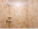 Shower with tan tile surround and built-in shelves at 141 Hobo Rd, Rotonda West, FL 33947