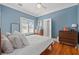 Serene bedroom features hardwood floors, blue walls, and ample natural light at 2747 3Rd N Ave, St Petersburg, FL 33713