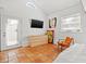 Bright bedroom with tiled floors, a dresser, and an orange chair at 2747 3Rd N Ave, St Petersburg, FL 33713