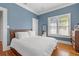 Bedroom with hardwood floors, blue walls, and mid-century modern furniture at 2747 3Rd N Ave, St Petersburg, FL 33713