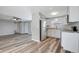 Modern kitchen with white cabinets, stainless steel appliances, and wood-look vinyl flooring at 3916 Middlesex Pl, Sarasota, FL 34241