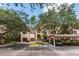 Exterior view of condo building with parking and landscaping at 4166 Central Sarasota Pkwy # 521, Sarasota, FL 34238