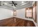 Spacious bedroom featuring hardwood floors, a tray ceiling, and ample natural light at 4205 Morning Breeze Ct, Tampa, FL 33619