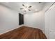 Bright bedroom featuring hardwood floors, ceiling fan, closet, and neutral paint at 4205 Morning Breeze Ct, Tampa, FL 33619