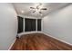 Cozy bedroom with hardwood flooring, neutral walls, and modern ceiling fan at 4205 Morning Breeze Ct, Tampa, FL 33619