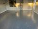 Garage featuring recently installed gray epoxy flooring, providing durability and aesthetic appeal at 4205 Morning Breeze Ct, Tampa, FL 33619