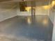 Garage features fresh gray epoxy flooring, a hot water heater, and room for plenty of storage at 4205 Morning Breeze Ct, Tampa, FL 33619